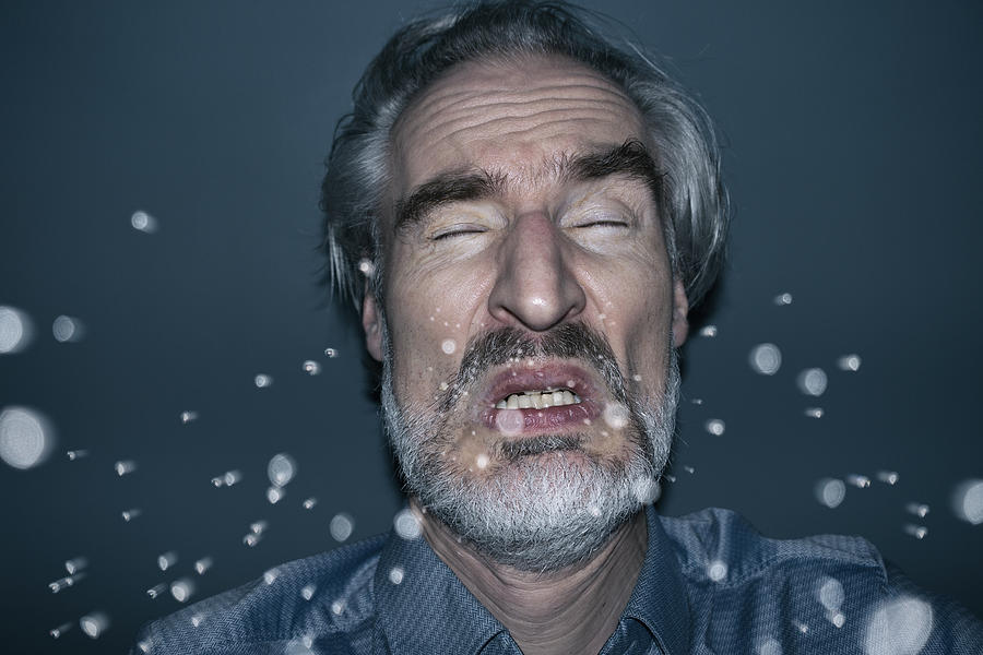 Sneezing man Photograph by Jorg Greuel