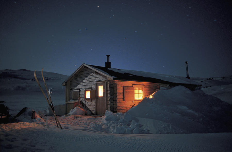 Snow Cabin At Night Photograph by Stockbyte