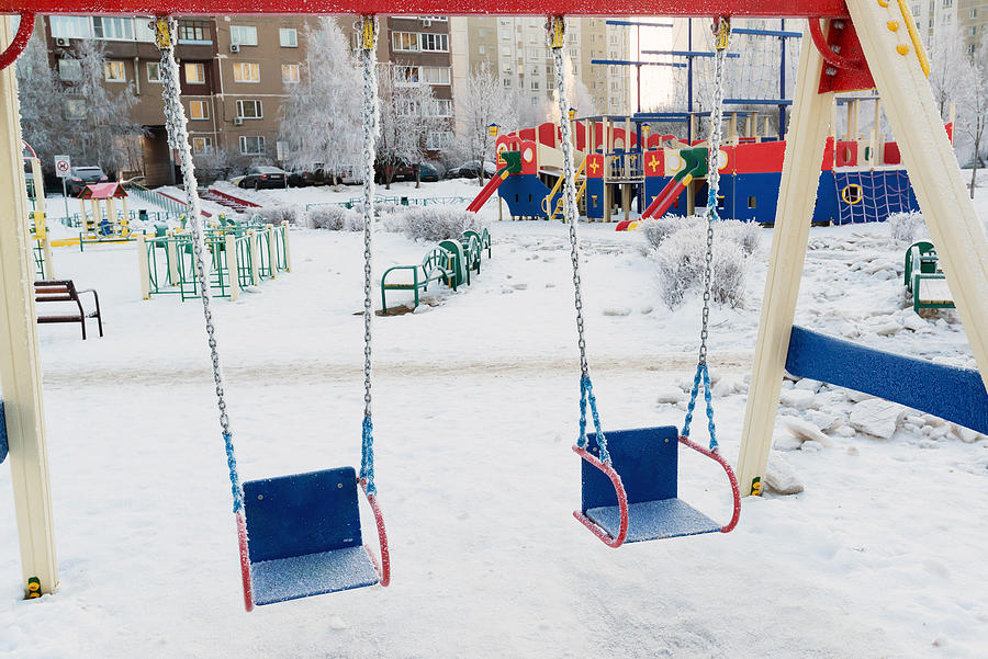 Snow Covered Swing And Slide At Playground In Winter Photograph by OlgaVolodina