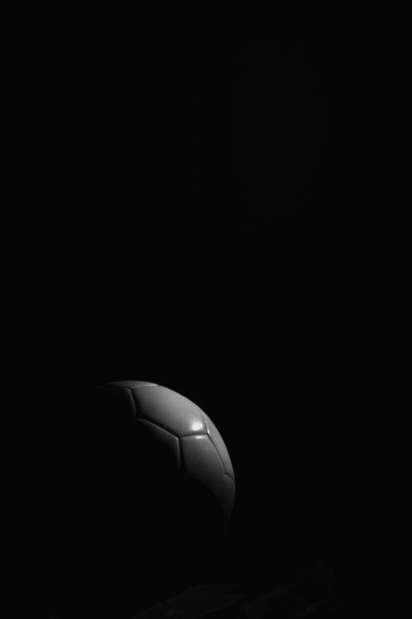 Soccer ball on black background Photograph by Westend61
