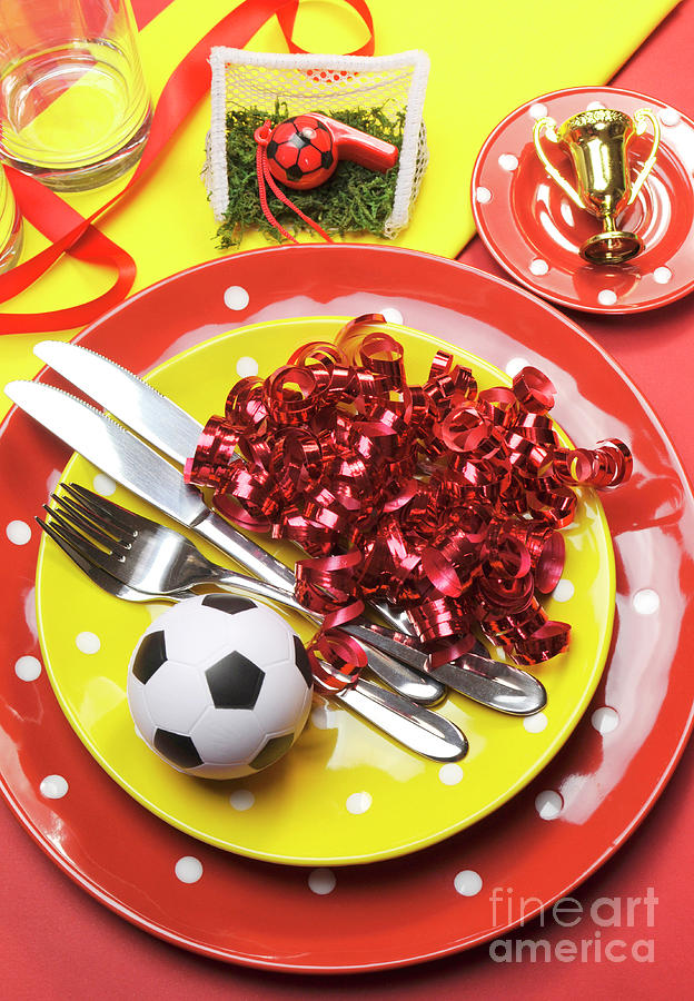 Soccer Photograph - Soccer football celebration party table settings in red and yellow team colors. by Milleflore Images