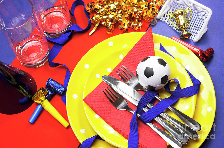 Soccer football celebration party table settings in red, yellow  Photograph by Milleflore Images