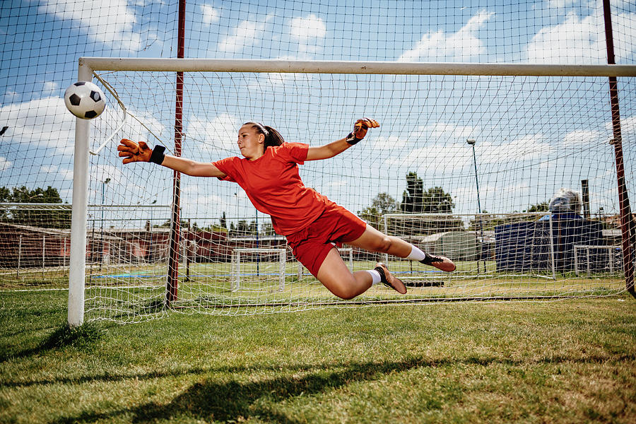 Soccer penalty kick with teen female goalkeeper Photograph by Drazen_