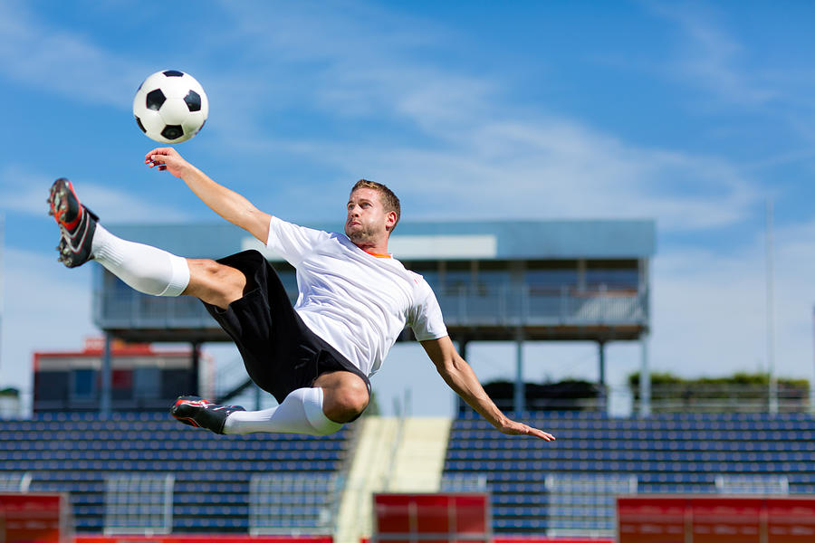 Soccer Player Bicycle Kick Photograph by Amriphoto
