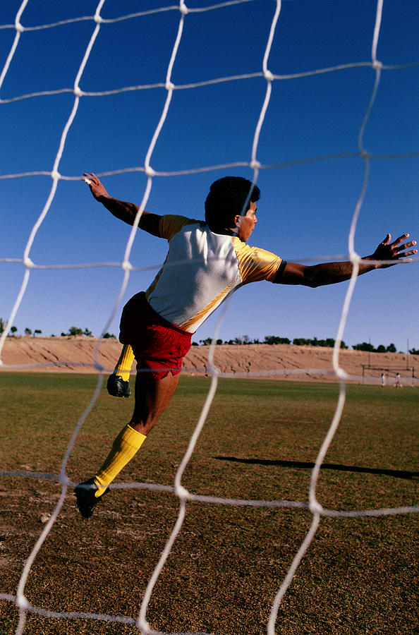 Soccer Player Viewed Thru Net Photograph by Marc Romanelli