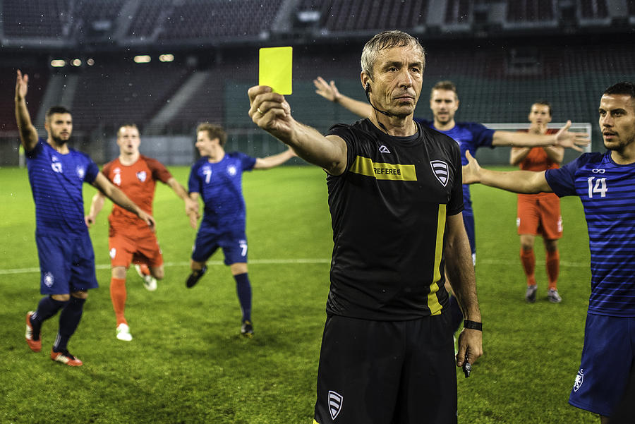 Soccer referee showing yellow card Photograph by Vm