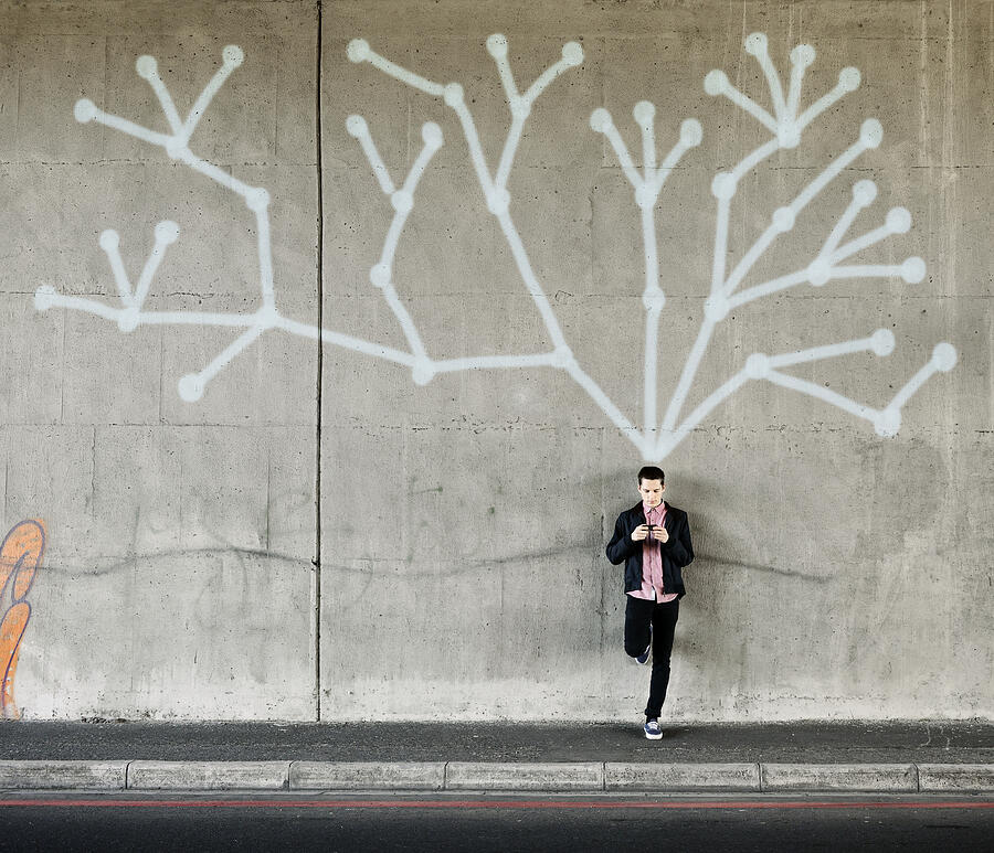 Social network on a wall behind a young man Photograph by David Malan