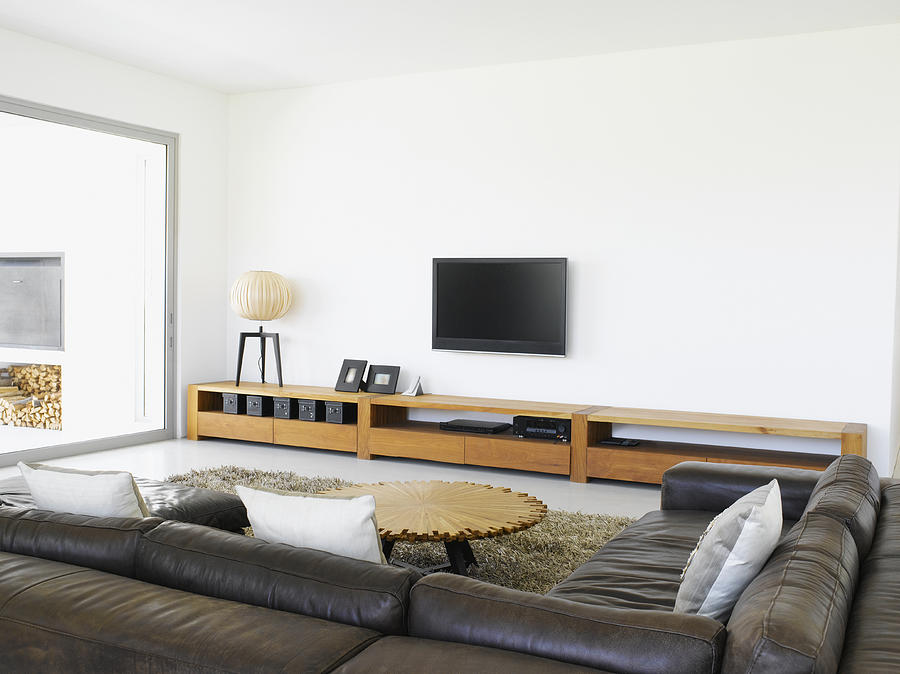 Sofa and television in living room of modern home Photograph by Robert Daly