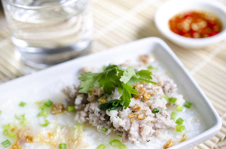 soft-boiled rice pork with Glass of water and fish sauce Photograph by Sirikornt
