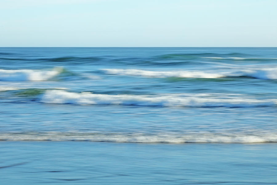 soft waves on a Pacific beach Photograph by Rainer Grosskopf
