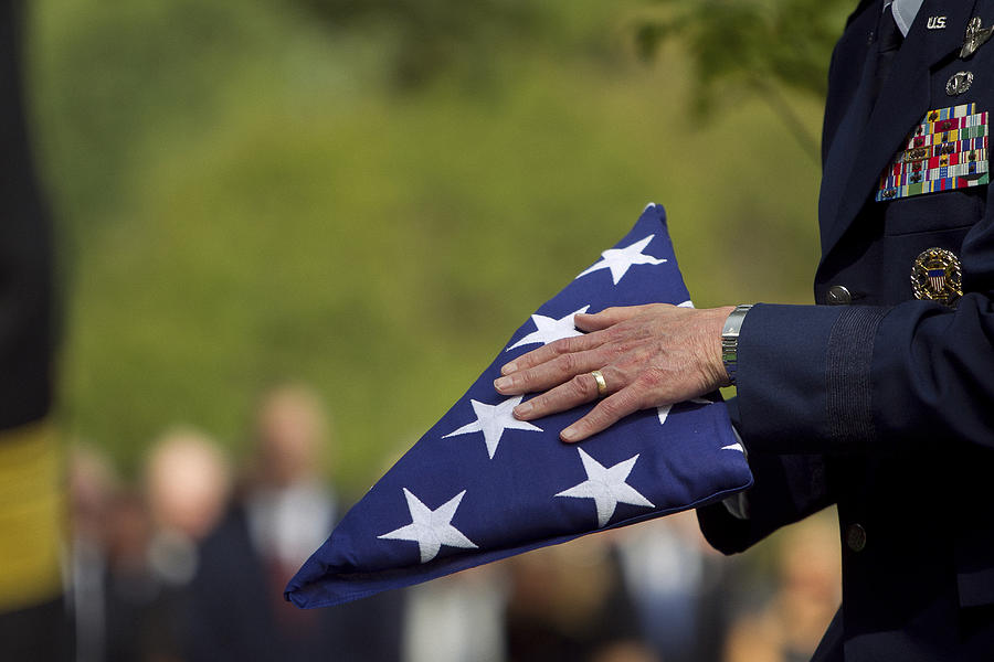 Soldier folding flag at military funeral Photograph by Jeff Greenough