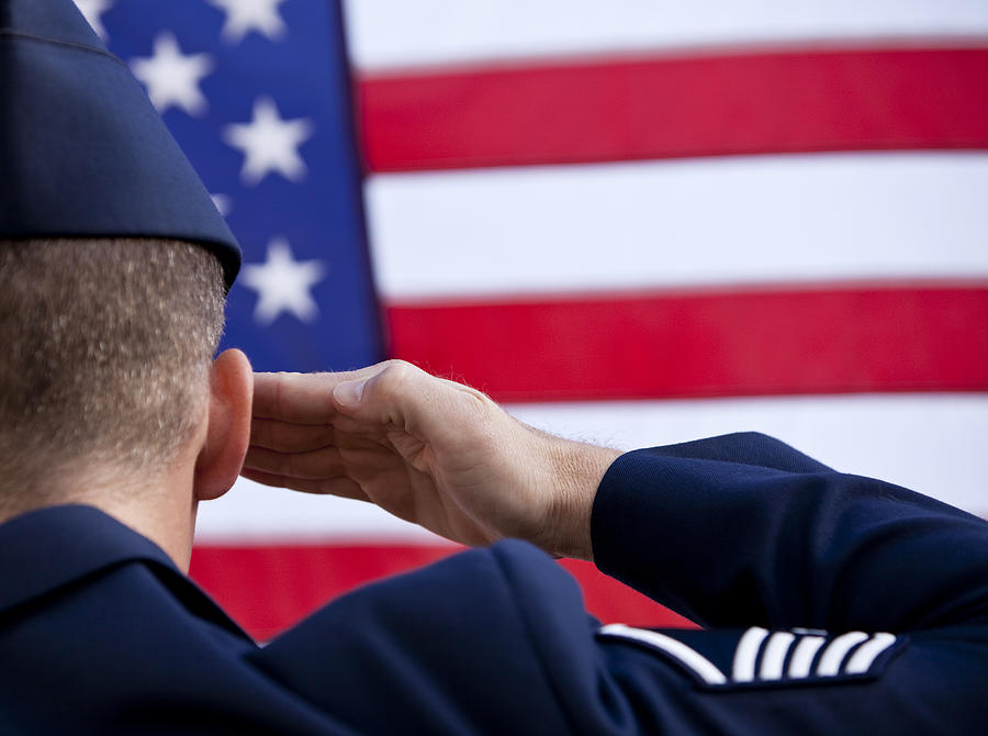 Soldier saluting American flag Photograph by CatLane