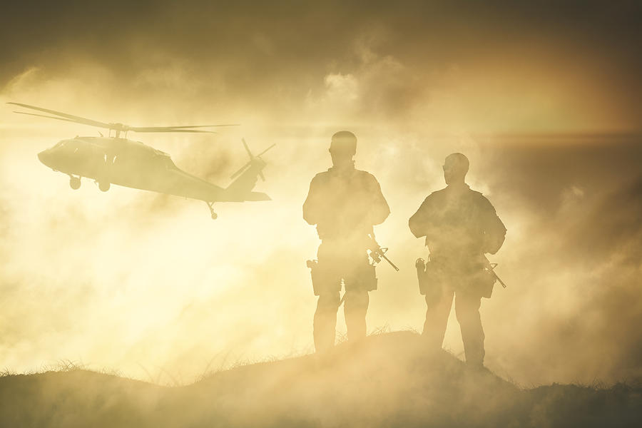 Soldiers wait for a Helicopter in Dust Storm Photograph by ninjaMonkeyStudio