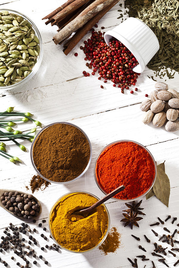 Some spices and herbs shot directly above on white table Photograph by Fcafotodigital