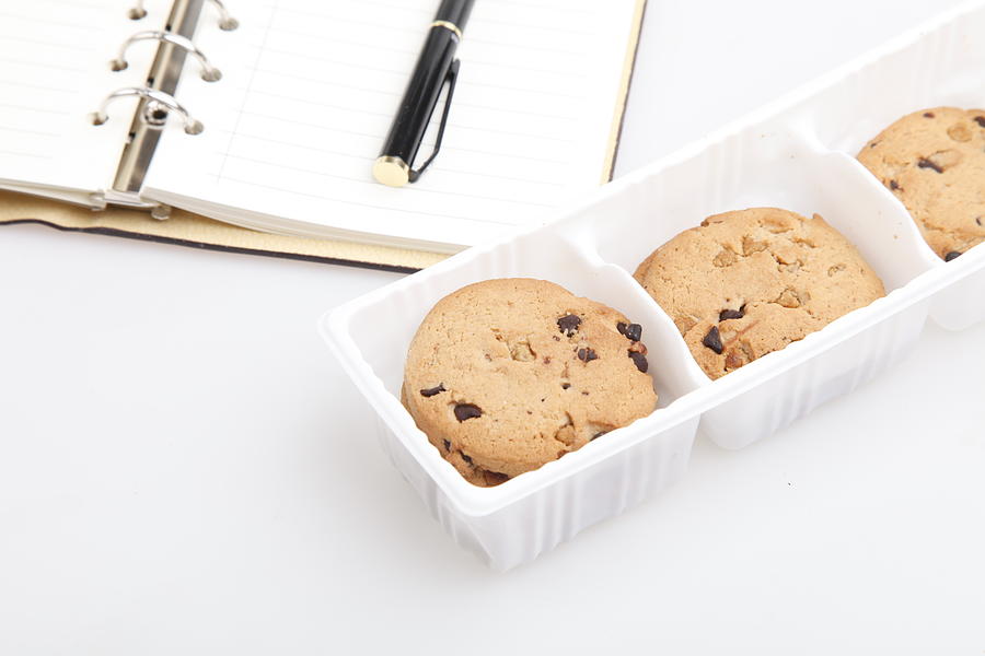 Some wheat biscuits with chocolate on the desk Photograph by Luxizeng