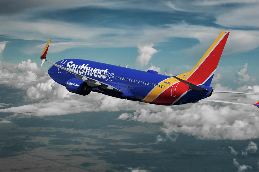 Southwest Airline Banking Toward the Clouds Mixed Media by Erik Simonsen