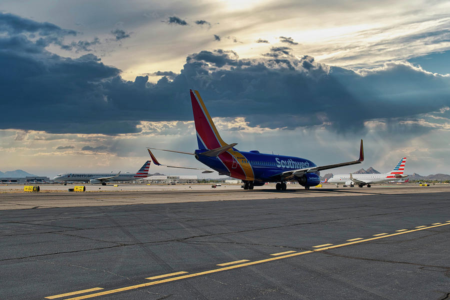 Southwest Boeing 737 behind an American Airlines Eagle CRJ taxie Photograph by Chris Smith