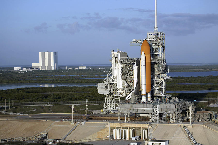 Space shuttle Atlantis atop the mobile launcher platform sits on the launch pad. Photograph by Stocktrek Images