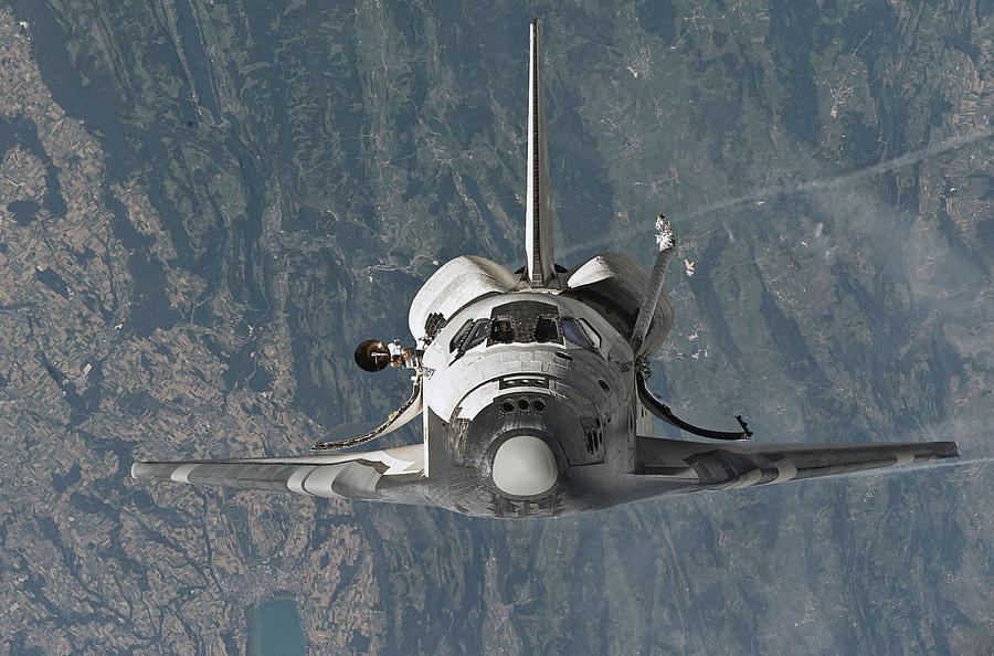 Space Shuttle Discovery Approaching The International Space Station - 2005 Photograph by War Is Hell Store