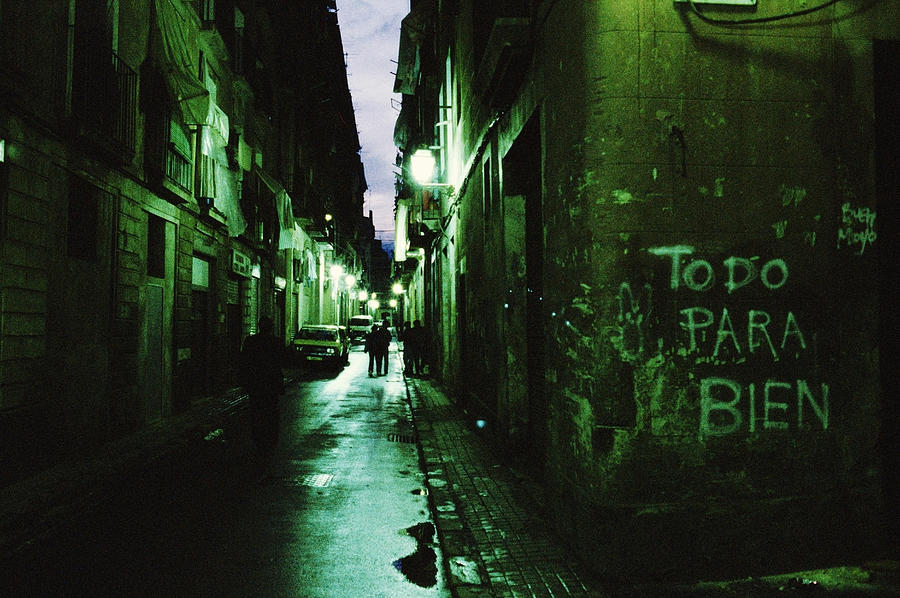 Spain, Barcelona, Barrio Chino, view down alley with grafitti Photograph by Christopher Pillitz