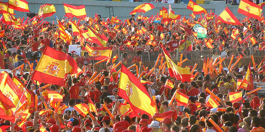 Spanish flags waving Photograph by By Eve Livesey