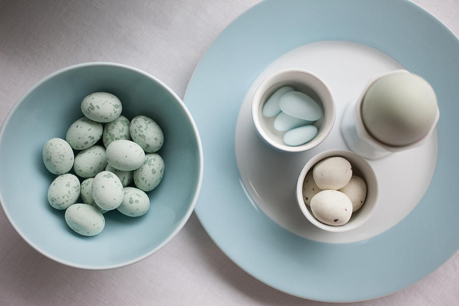 Speckled blue candy eggs in bowl Photograph by Tom Merton
