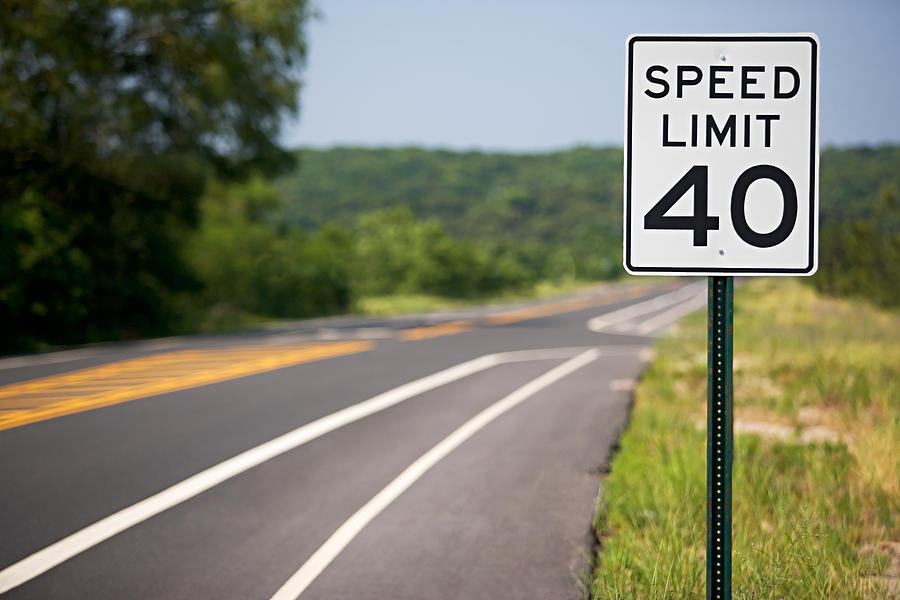 Speed limit sign by the road Photograph by Image Source