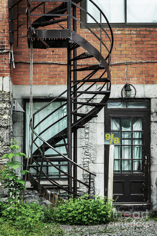Architecture Photograph - Spiral stairs and door in Montreal by Delphimages Photo Creations