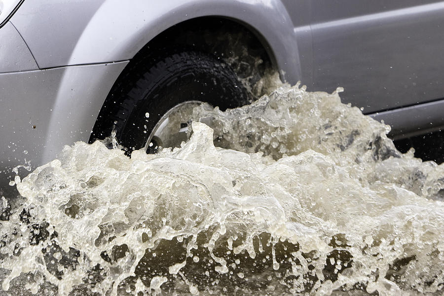 Splash by a car as it goes through flood water Photograph by ChrisCrafter