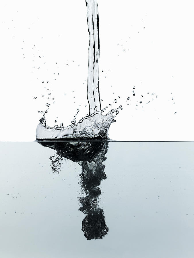 Splash of water, studio shot Photograph by Ryan McVay