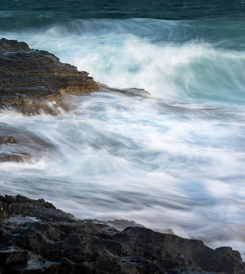 Splashing stormy windy sea waves on a rocky seashore Photograph by Michalakis Ppalis