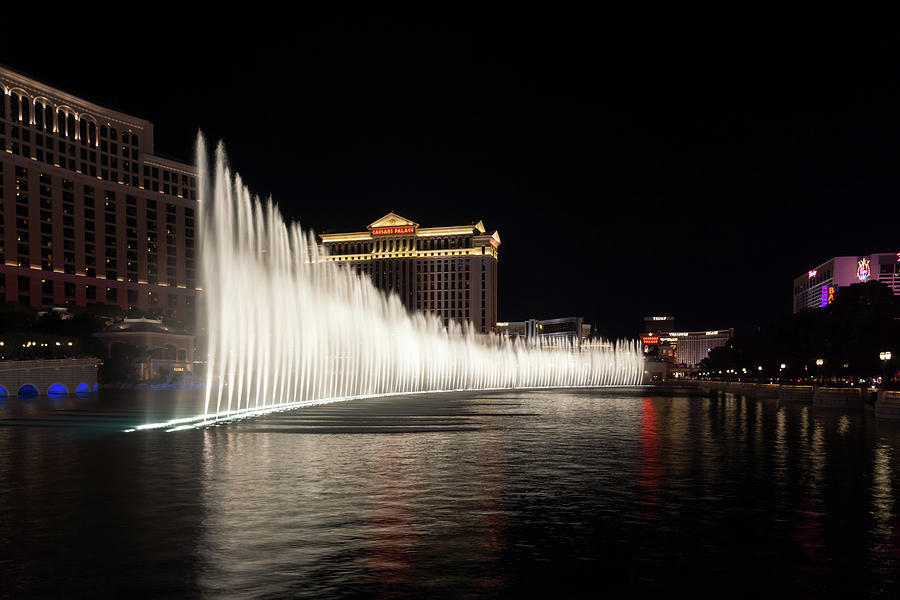Splendiferous Las Vegas Fountains - Caesars Palace Behind a Curtain of Water at Midnight Photograph by Georgia Mizuleva