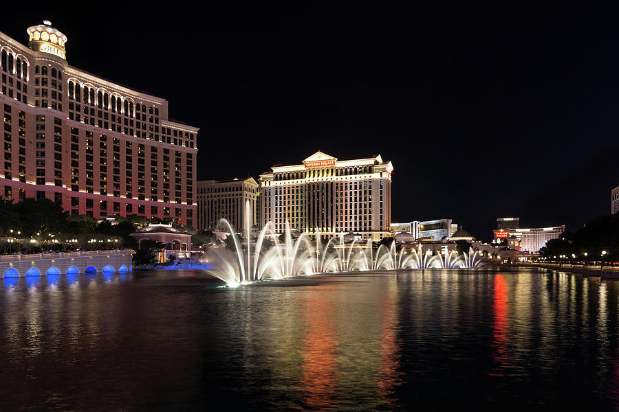 Splendiferous Las Vegas Fountains - Dainty Jets with Bellagio and Caesars Palace at Midnight Photograph by Georgia Mizuleva