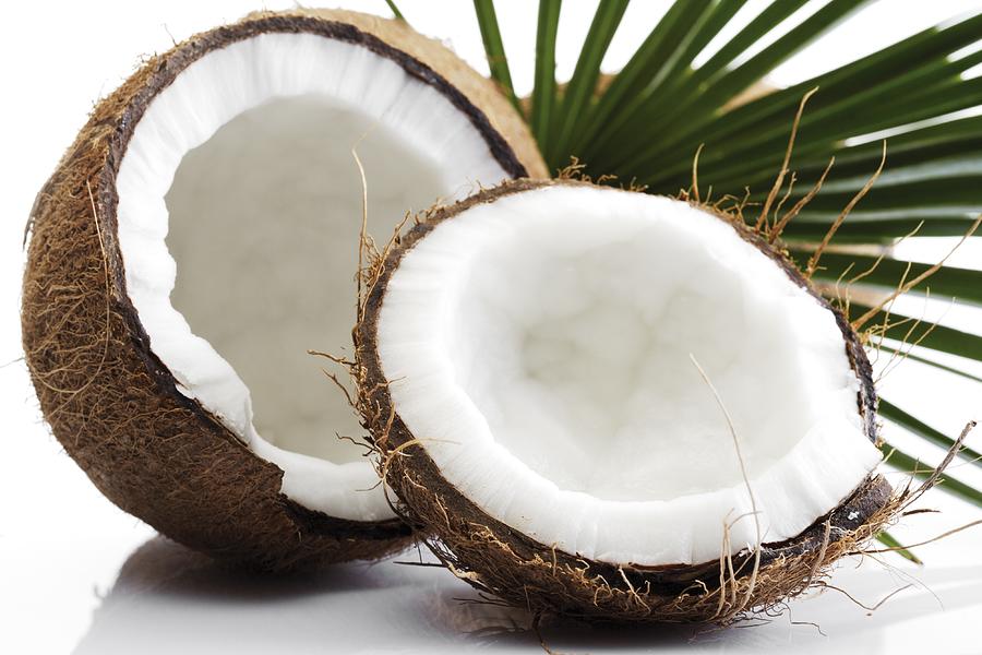 Split coconuts, close-up Photograph by Creativ Studio Heinemann