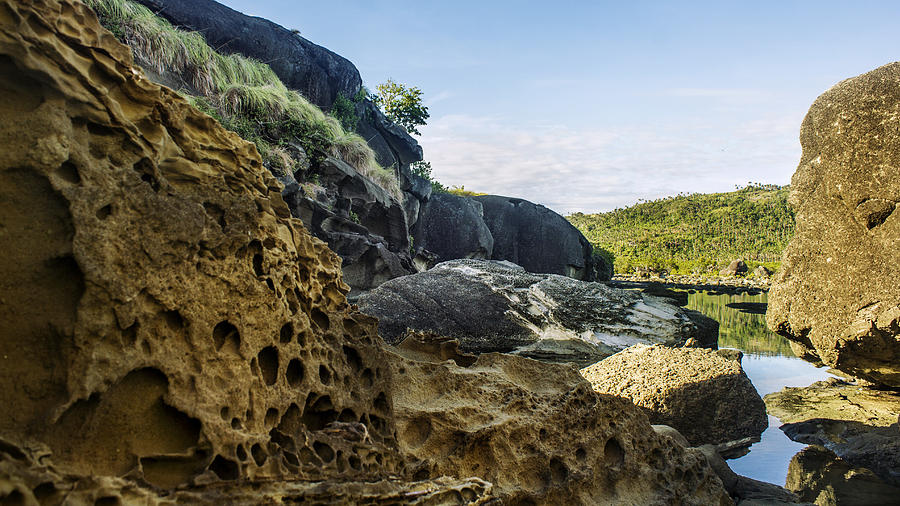 Sponge looking rocks on foreground at Biri Island Photograph by Chris Dela Cruz