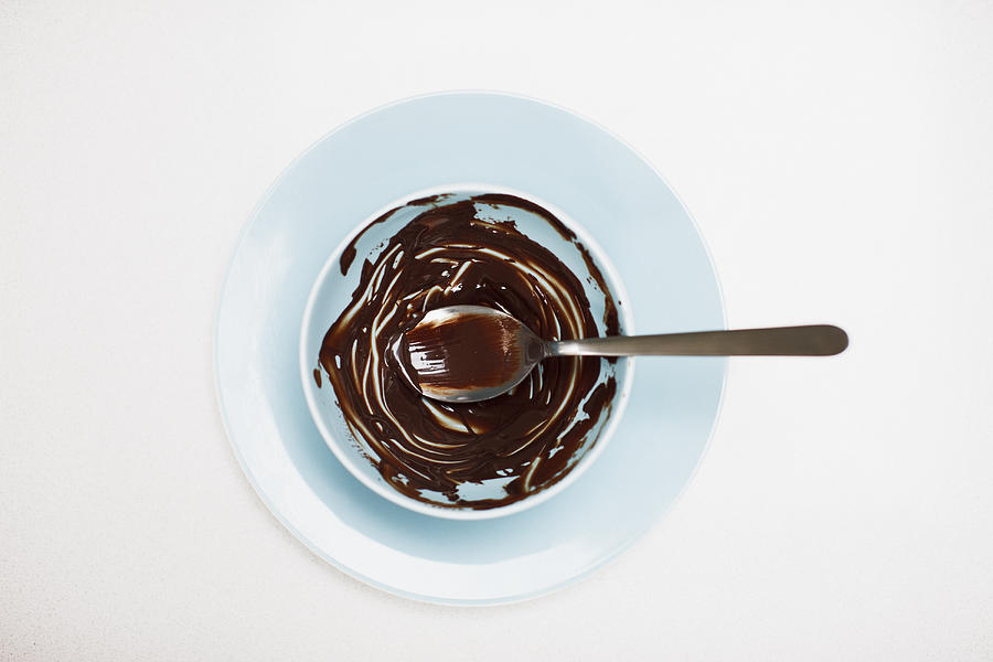 Spoon in bowl with remaining chocolate batter Photograph by Tom Merton
