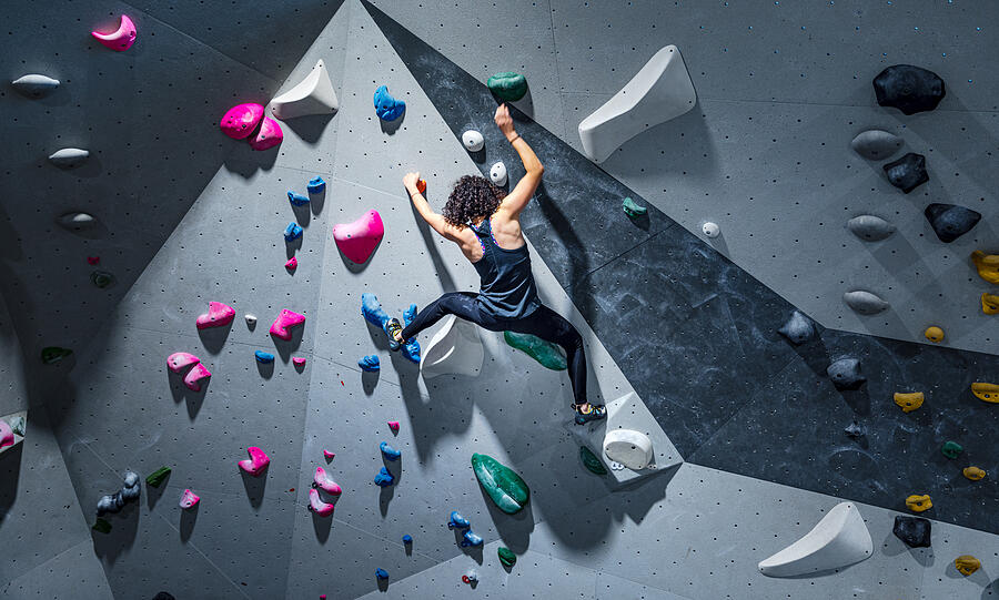 Sportswoman training climbing on indoor climbing wall Photograph by Fotodelux Sportswoman training climbing on indoor climbing wall Photograph by Fotodelux