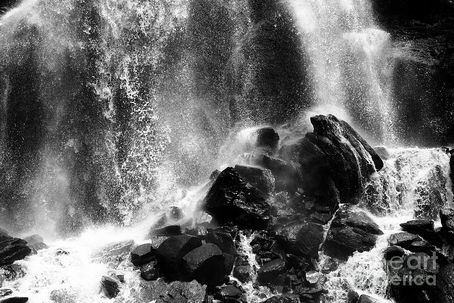 Spray and rocks in black and white Photograph by James Brunker