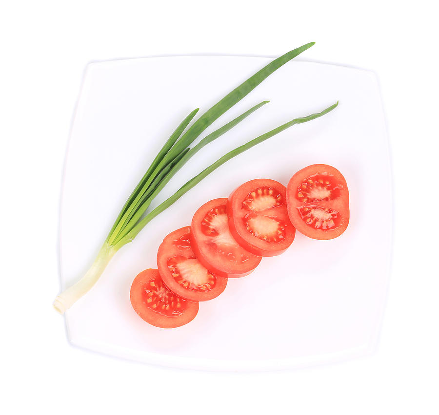 Spring onions and sliced tomatoes. Photograph by Indigolotos