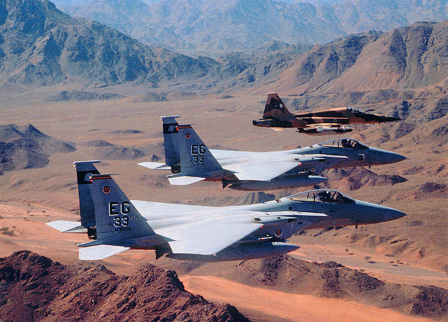 Squadron of military airplanes over desert mountains Photograph by Frank Rossoto Stocktrek