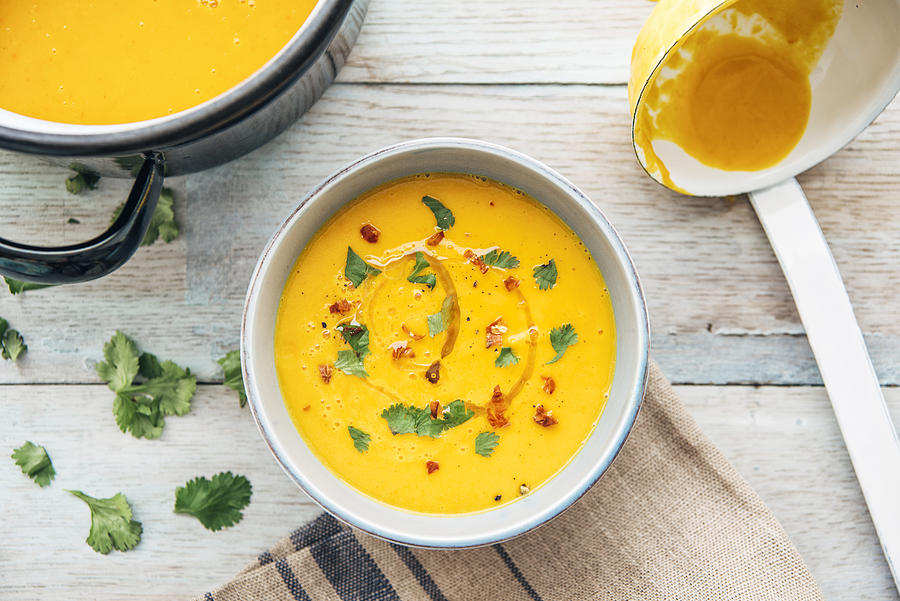Squash soup with cilantro and chili Photograph by Westend61