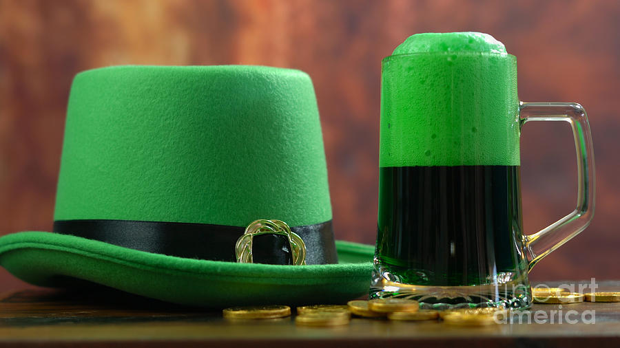 St Patricks Day pouring green beer with green leprechaun hat Photograph by Milleflore Images