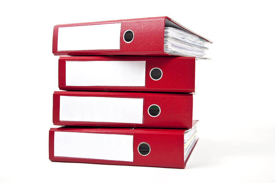 Stack of four red ring binders with spine facing viewer Photograph by Bertlmann