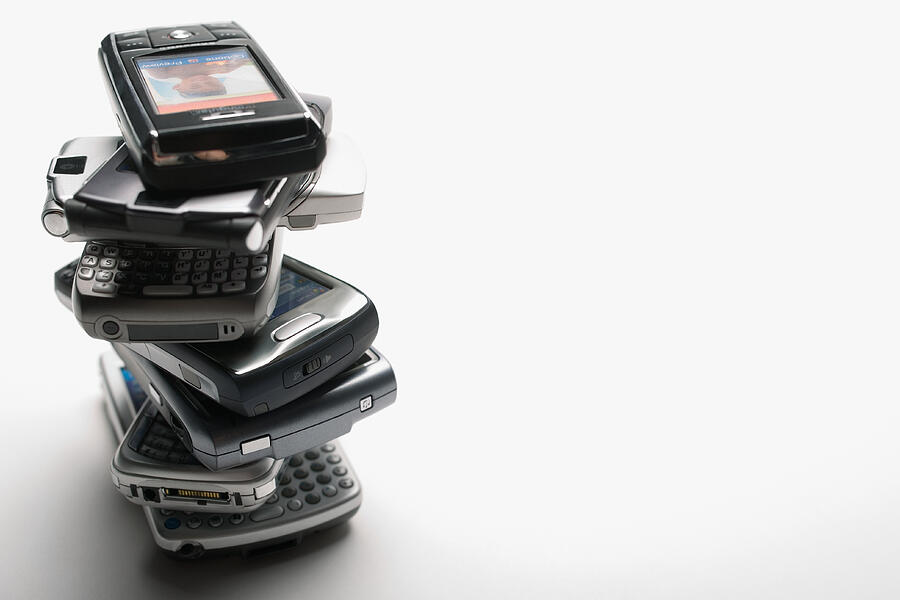 Stack of mobile telephones Photograph by Jupiterimages