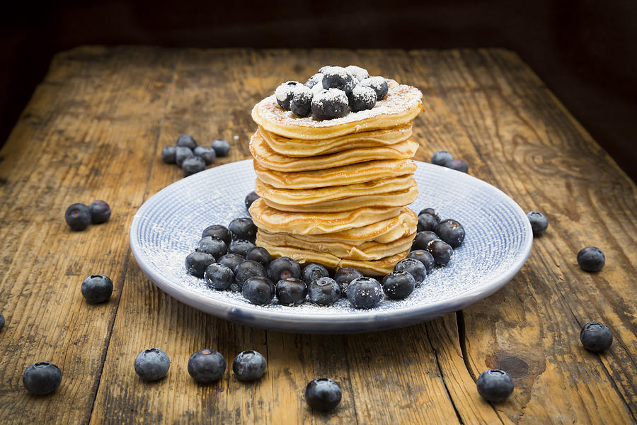 Stack of Pancakes with blueberries on blue plate Photograph by Larissa Veronesi