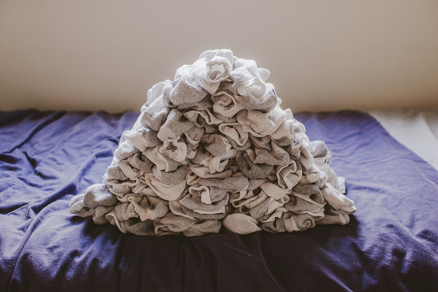 Stack of socks on top of bed Photograph by Kevin C Moore