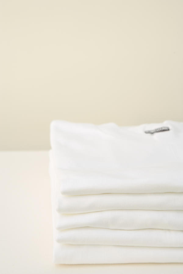Stack of white t-shirts Photograph by Walter B. McKenzie