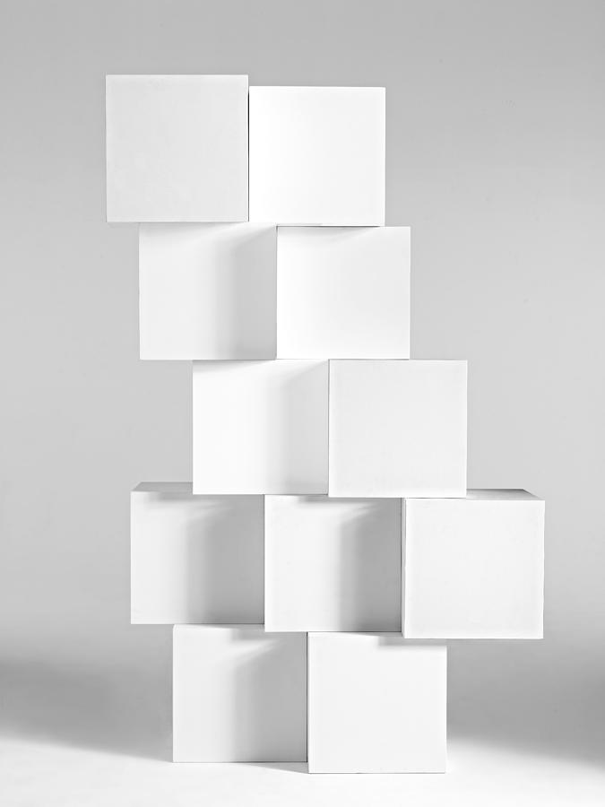 Stacked blocks in white background Photograph by Bill Diodato