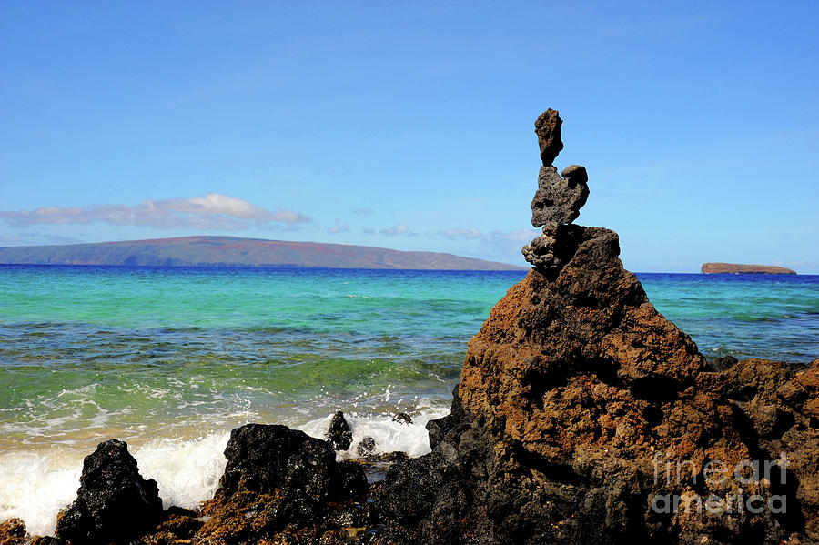 Stacked rocks in front of the blue ocean of Maui, Hawaii Photograph by Gunther Allen