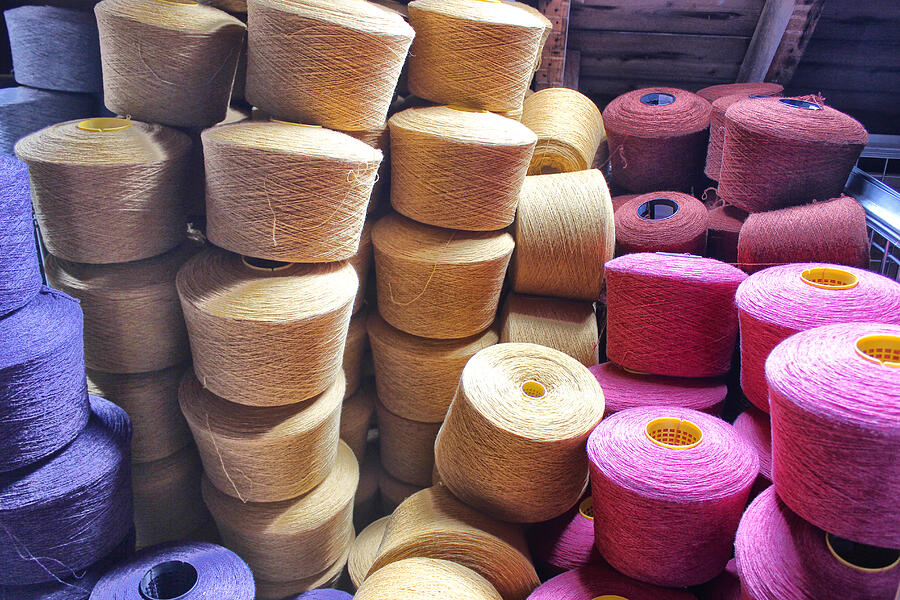 Stacked spools of dyed wool Photograph by larigan - Patricia Hamilton